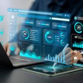 Foto: Antony Weerut - Adobe Stock Eine Person sitzt am Laptop, es sind Statistiken und AI-Symbole über ihren Händen eingeblendet.